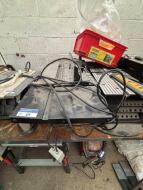 Remaining Loose and Removable decommissioned equipment to include DEWALT Chop Saw; 2 TREND Router Tables; 2 Table Saws; Mig Welder and Various Machine Parts - Note: Condition Unknown - 5