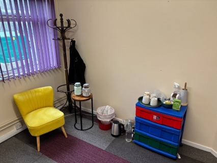 Contents to Waiting Room to include a Plastic Three Drawer Storage Unit with Various Crockery and Cutlery, Coat Stand, Coffee Table and Upholstered Chair